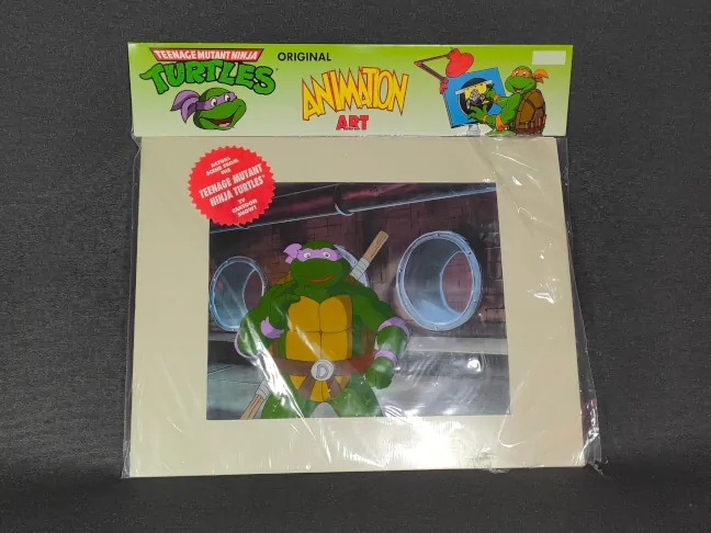 Imagen de un Animation Cel de Las Tortugas Ninja con su embalaje original